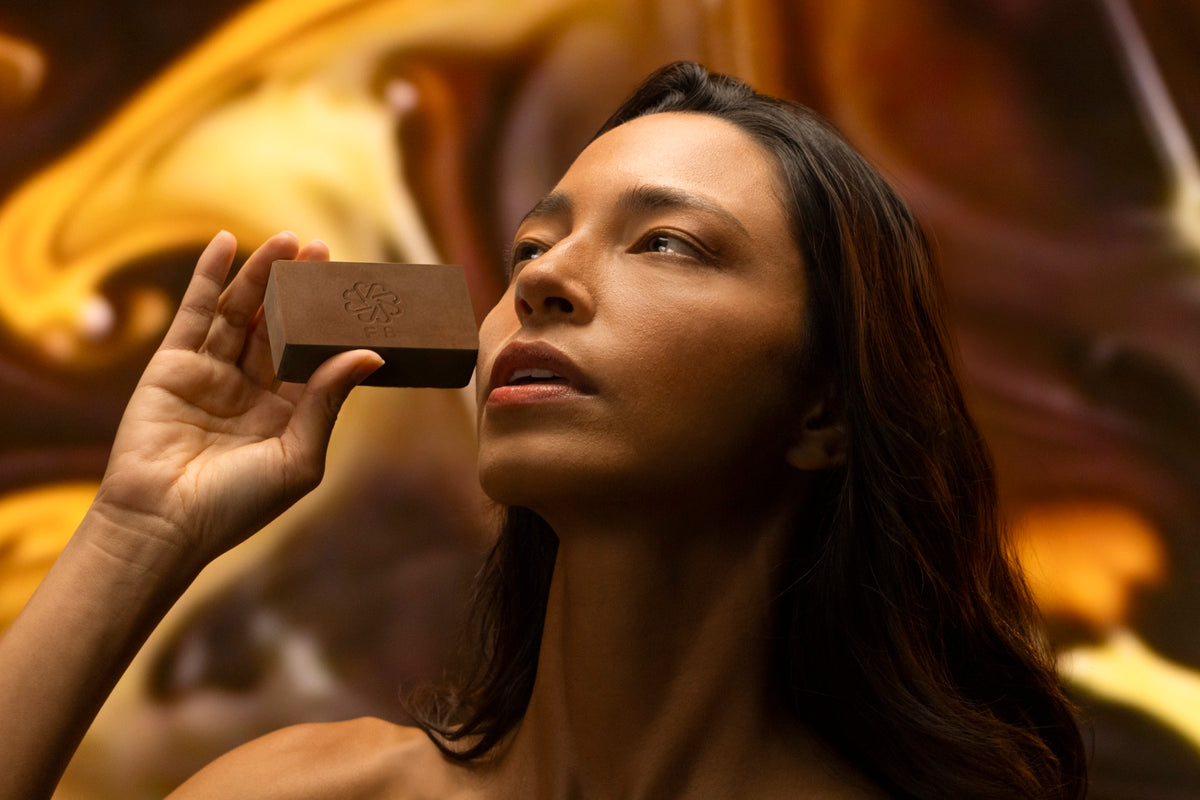 Woman holding a JIVANTRA solid cleansing bar — brand story